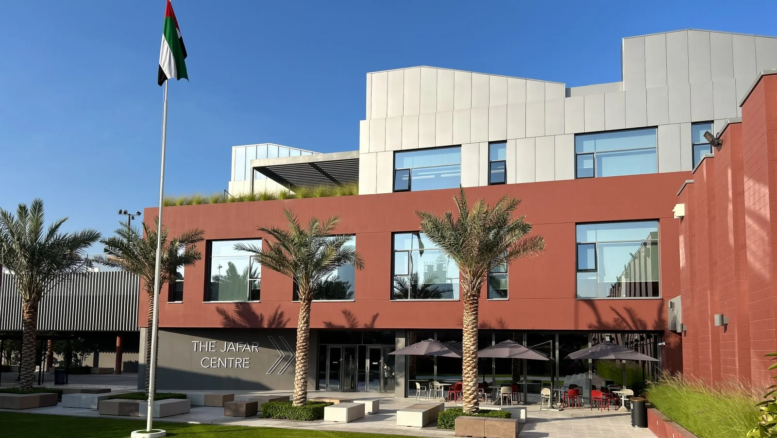 Dubai College’s Jafar Centre, showing its terracotta facade, courtyard and palms